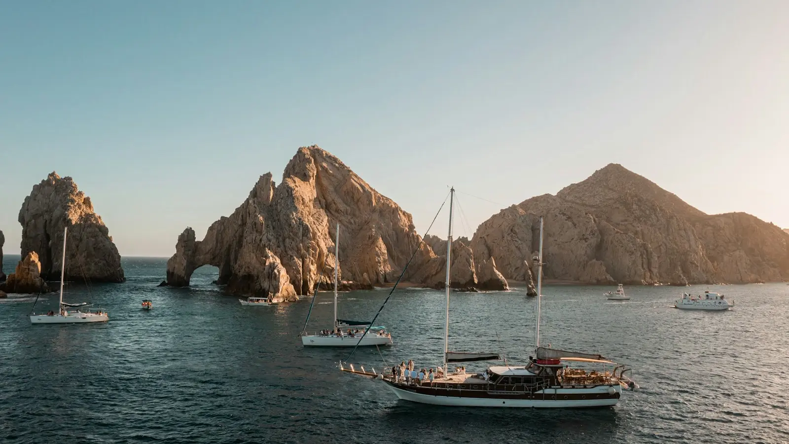 Sailboats gathered near the Land's End rock formations in Cabo San Lucas